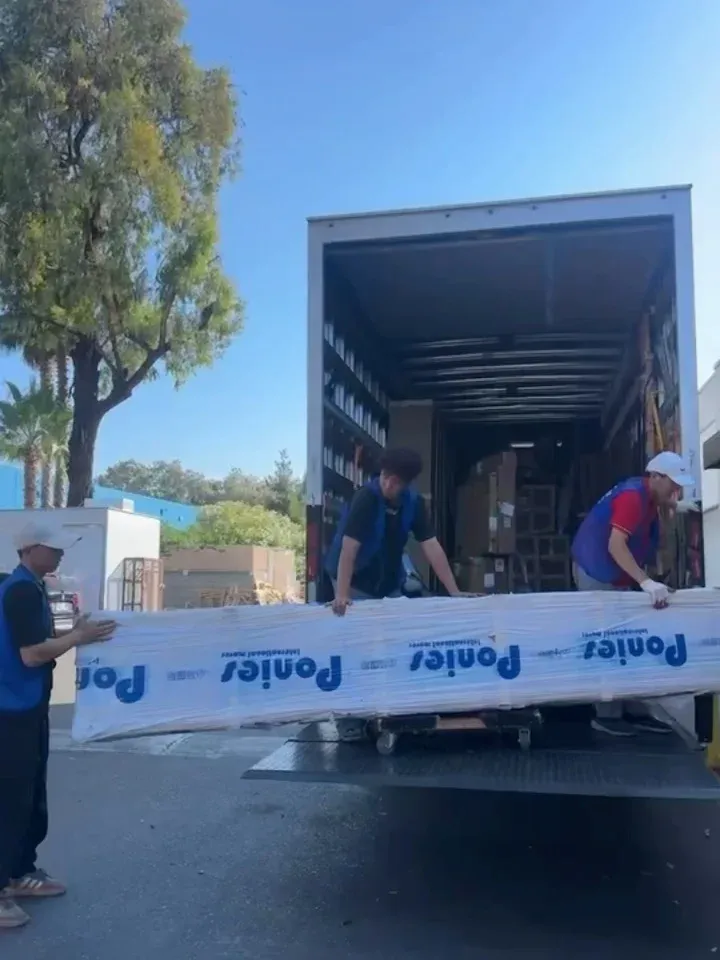 Delivery day in California: the container load arrives and the crew unloads.
