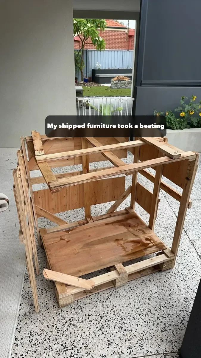 A broken wooden frame from a Perth buyer's shipment; almost everything except the dining chairs arrived damaged.