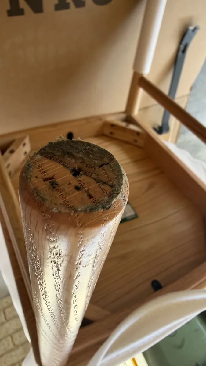 A chair leg photographed by a Perth buyer after a shipment in which the bottom chairs of a batch arrived with mould.