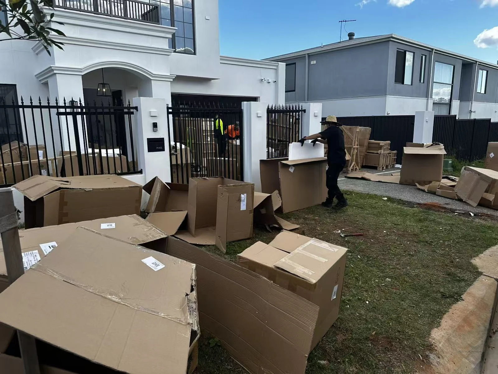 Cartons and timber packing materials being gathered outside the Melbourne property
