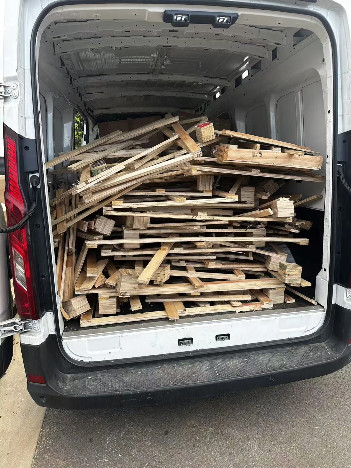 Used timber frames collected in a van for removal after unpacking