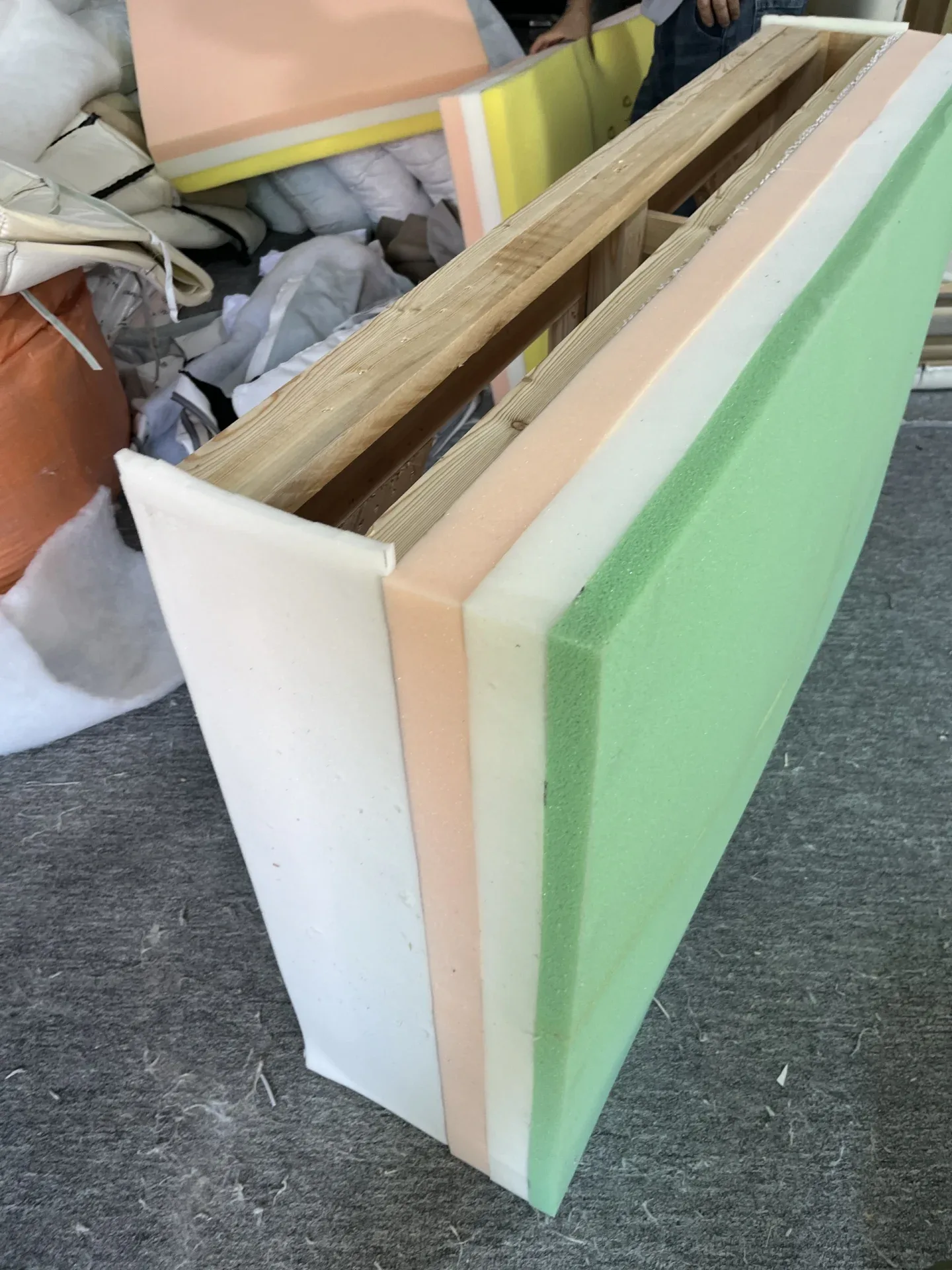 Foam of different densities glued in layers onto a frame, from the same maker's post. Ask for photos at this stage, with the density labels, before.