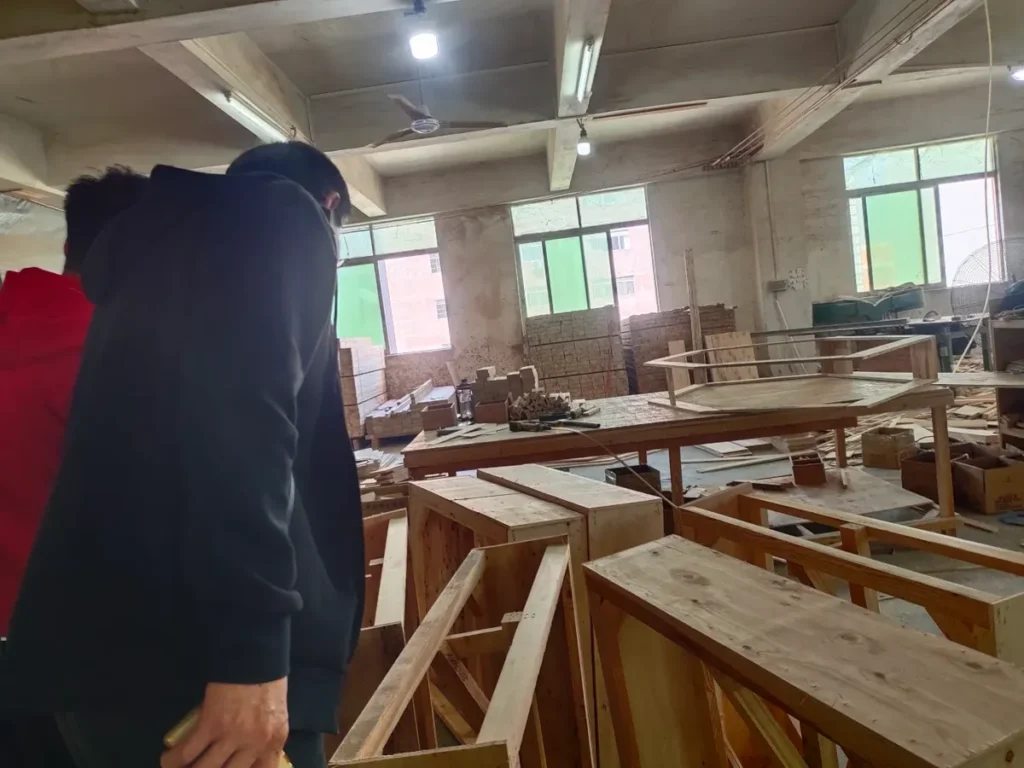 A frame workshop filmed on a walk-through: bare timber frames are the stage to check before foam and fabric hide them.