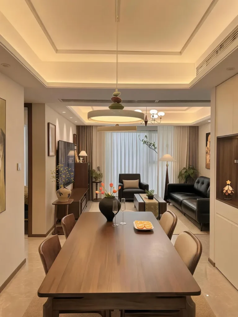 A walnut living-dining room finished with pendant lighting, sheer curtains and a floor lamp — the soft furnishings are what make the furniture look.