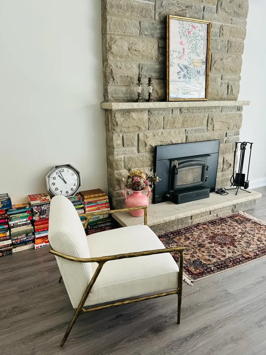 A lounge chair shipped from China, in place beside a stone fireplace in a Canadian home.