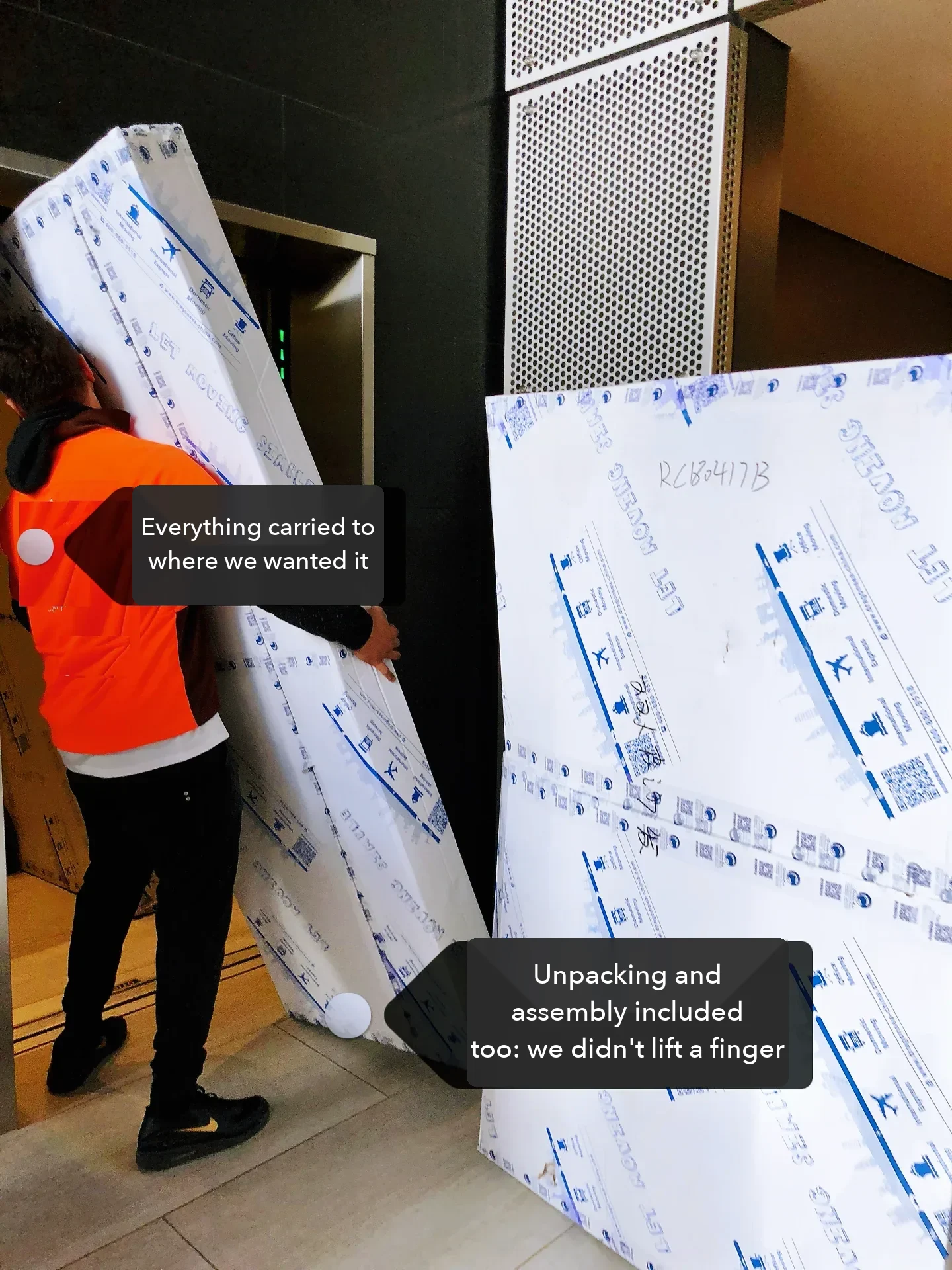 Delivery crew carrying wrapped panels into the building; in this buyer's case unpacking and assembly were included.