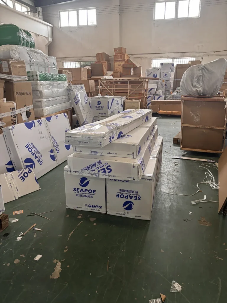 Customers' furniture being re-packed in a mover's warehouse in China before shipping to Canada.