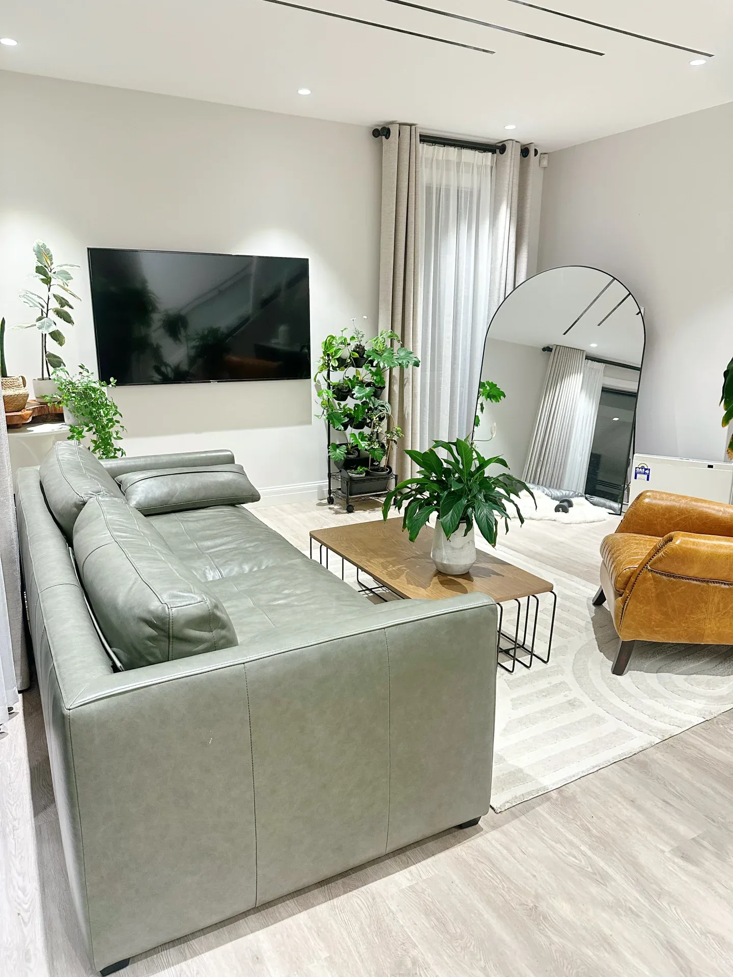 A leather sofa and armchair shipped from China, set up in the same New Zealand living room.