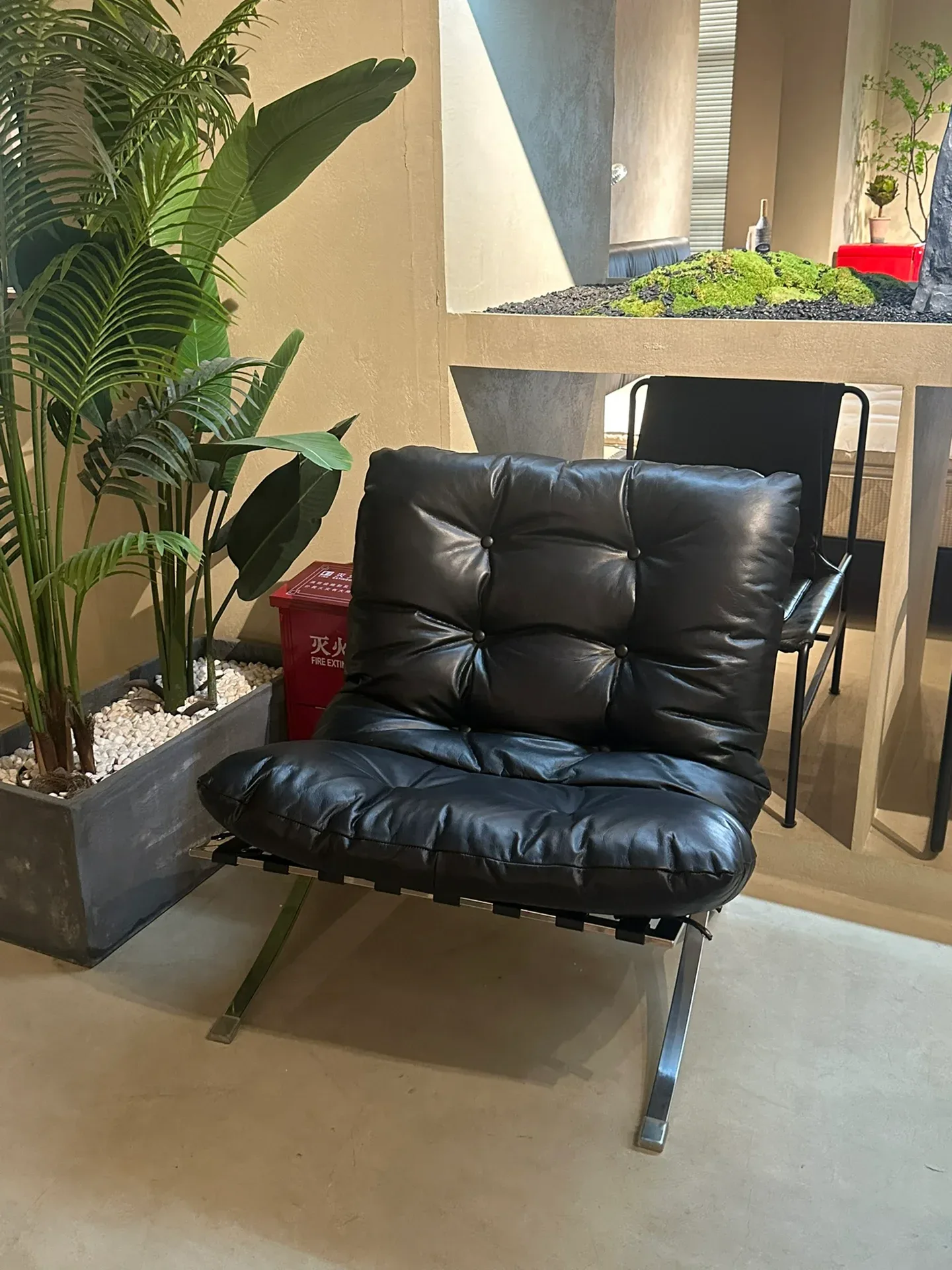 A tufted leather lounge chair on a stainless-steel frame, seen in a Foshan showroom a buyer reviewed. At the specification stage each piece like this.