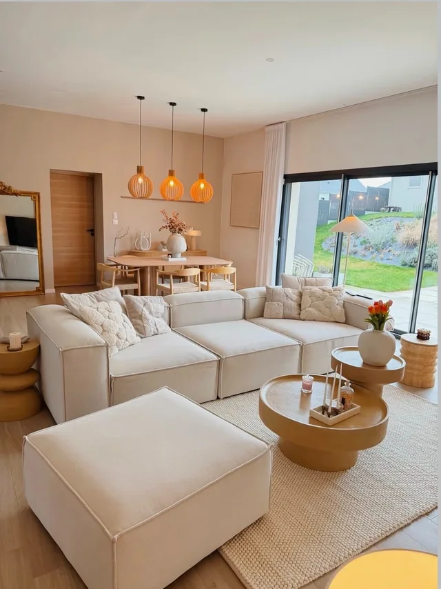 Australian living room with a cream sectional sofa and round coffee table