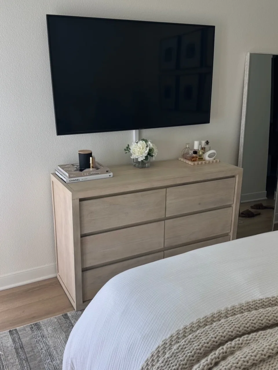 Bedroom chest and television beside a bed at the Milan home
