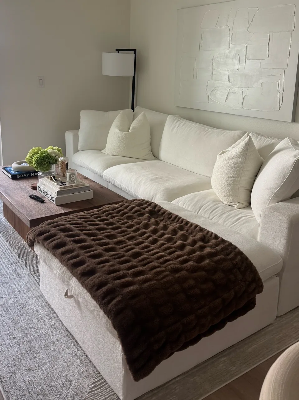 Milan living room with cream seating and a dark woven coffee table