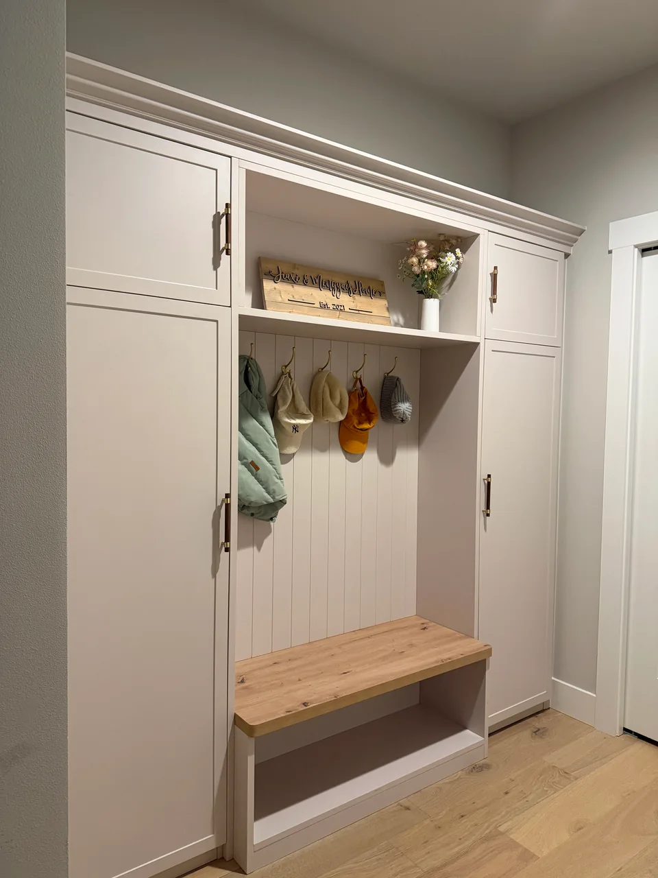 Custom shoe cabinet with open shelves, hooks and a low bench