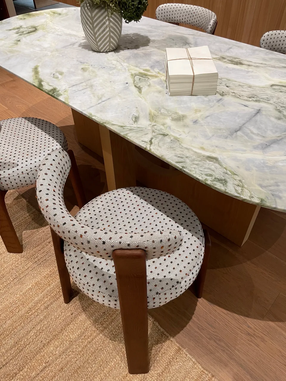 Patterned dining table with upholstered dining chairs