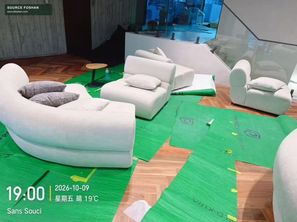 Curved upholstered sofa with temporary floor protection during Sydney furniture installation