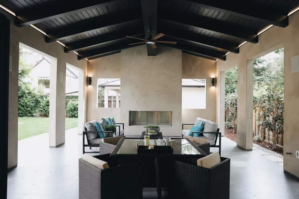 Outdoor lounge seating and dining furniture on a covered patio