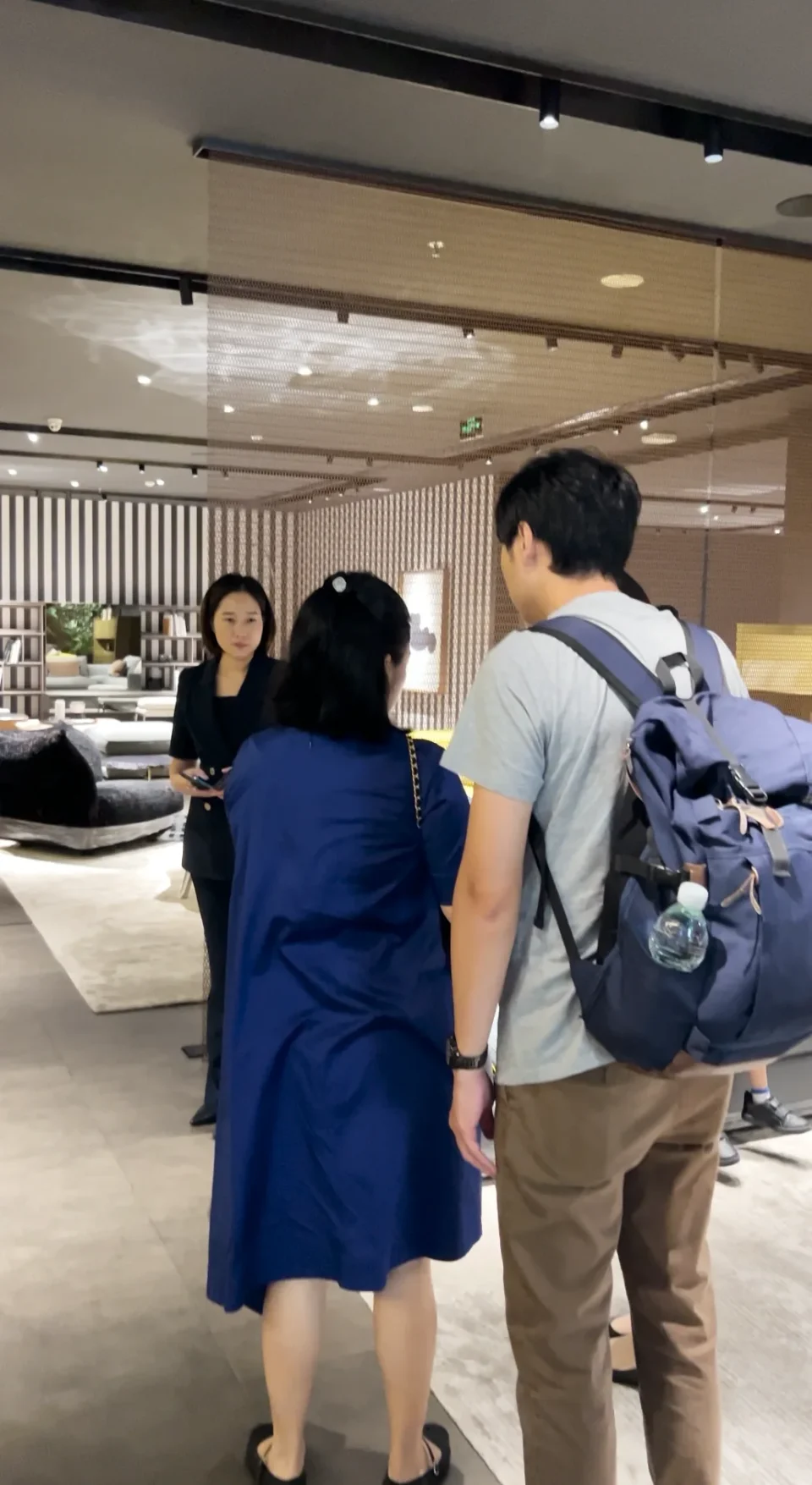 Visitors walking with a guide through furniture displays in Foshan.
