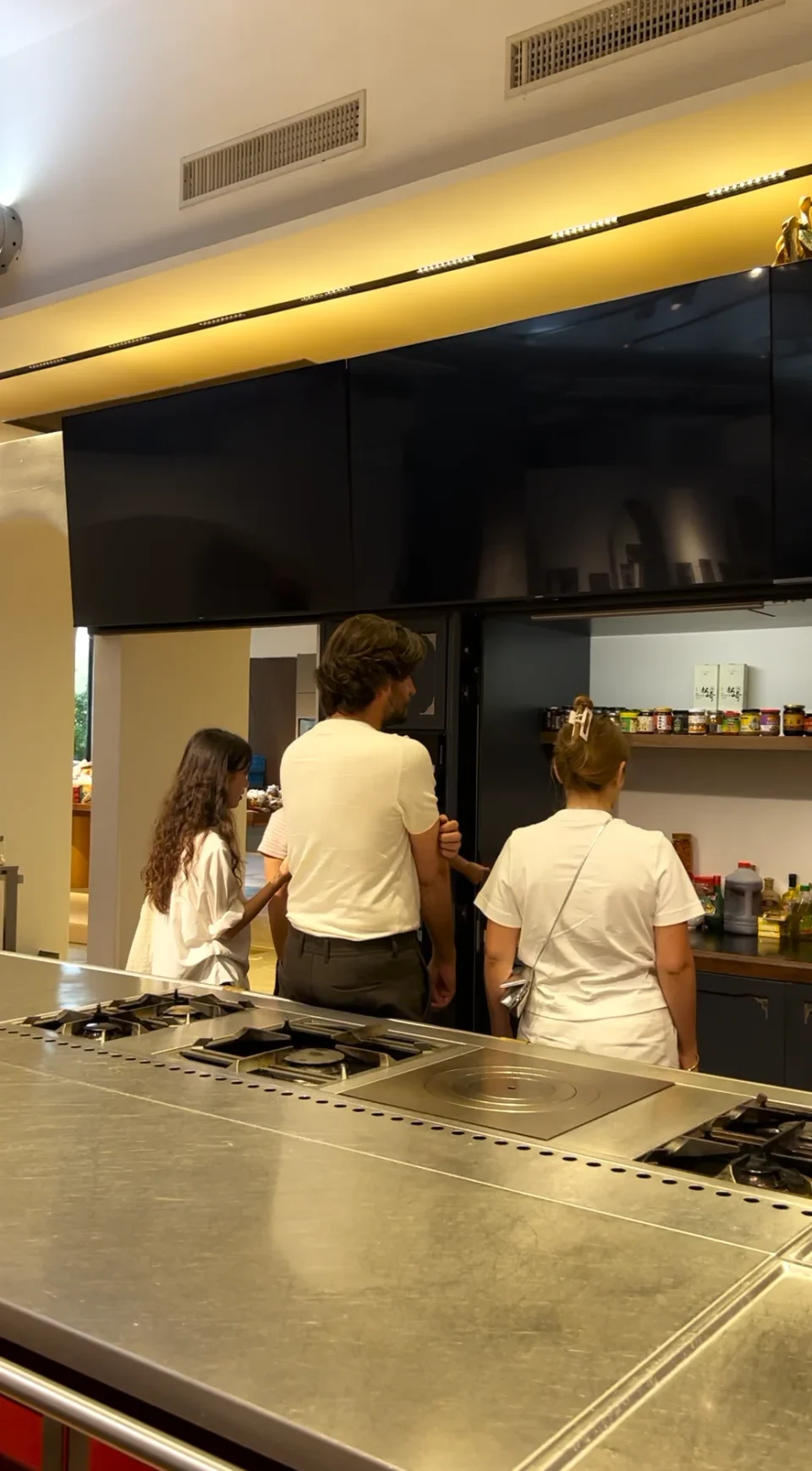 Visitors discussing a kitchen display with showroom staff.